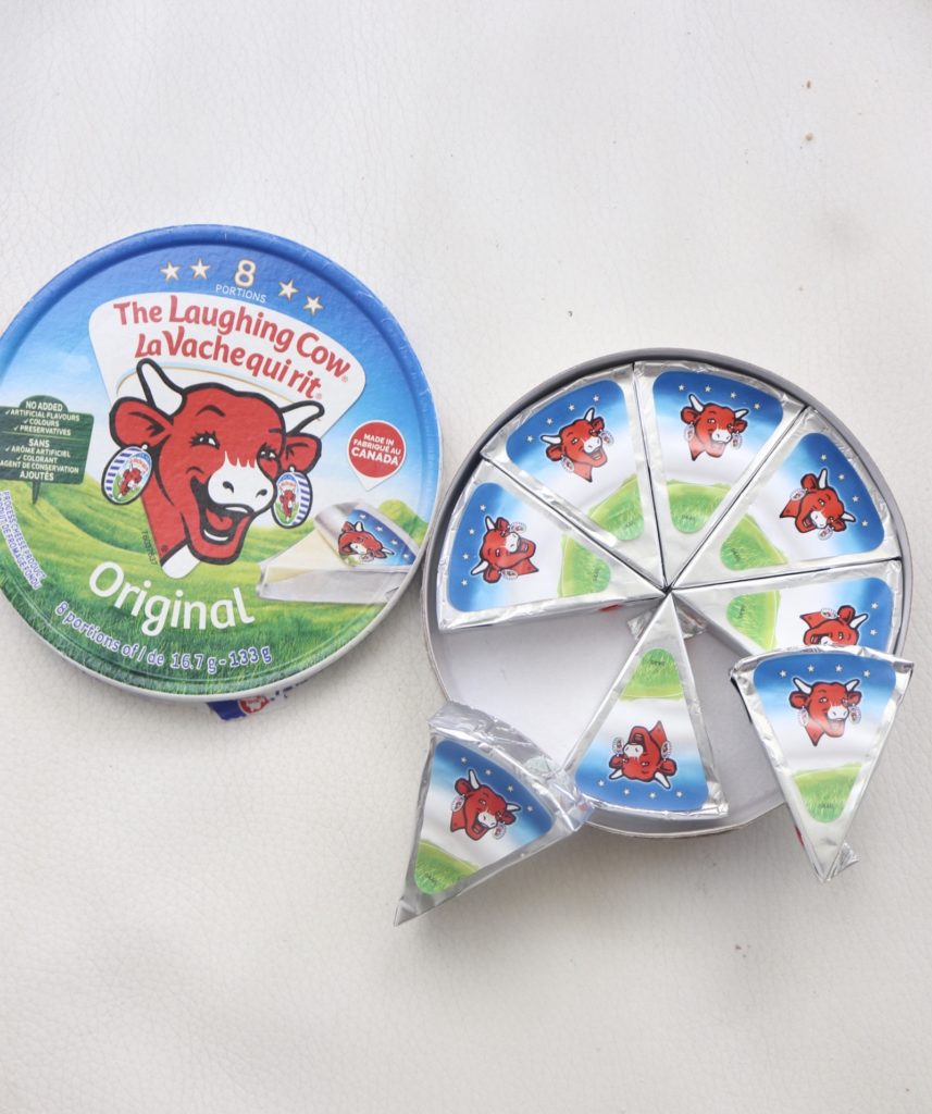 The laughing cow cheese wedges on a white background.