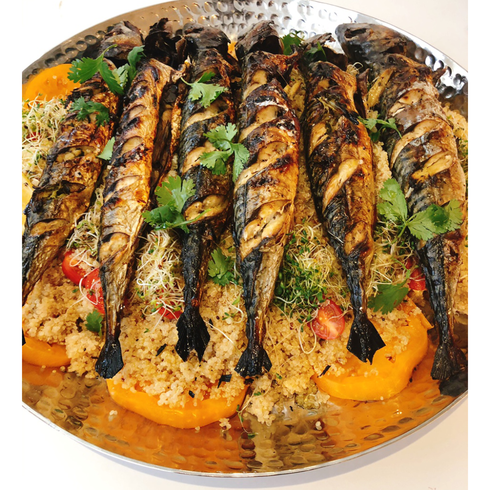 broiled mackerel with quinoa on a platter