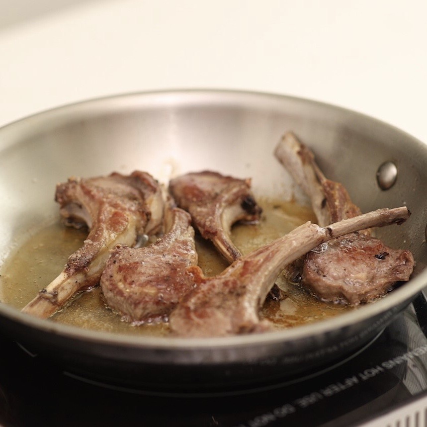Lamb chops in sauce pan on the stove