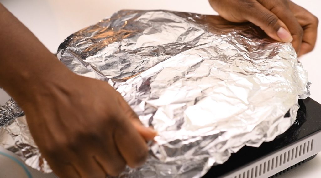 cast iron pan covered with foil paper.