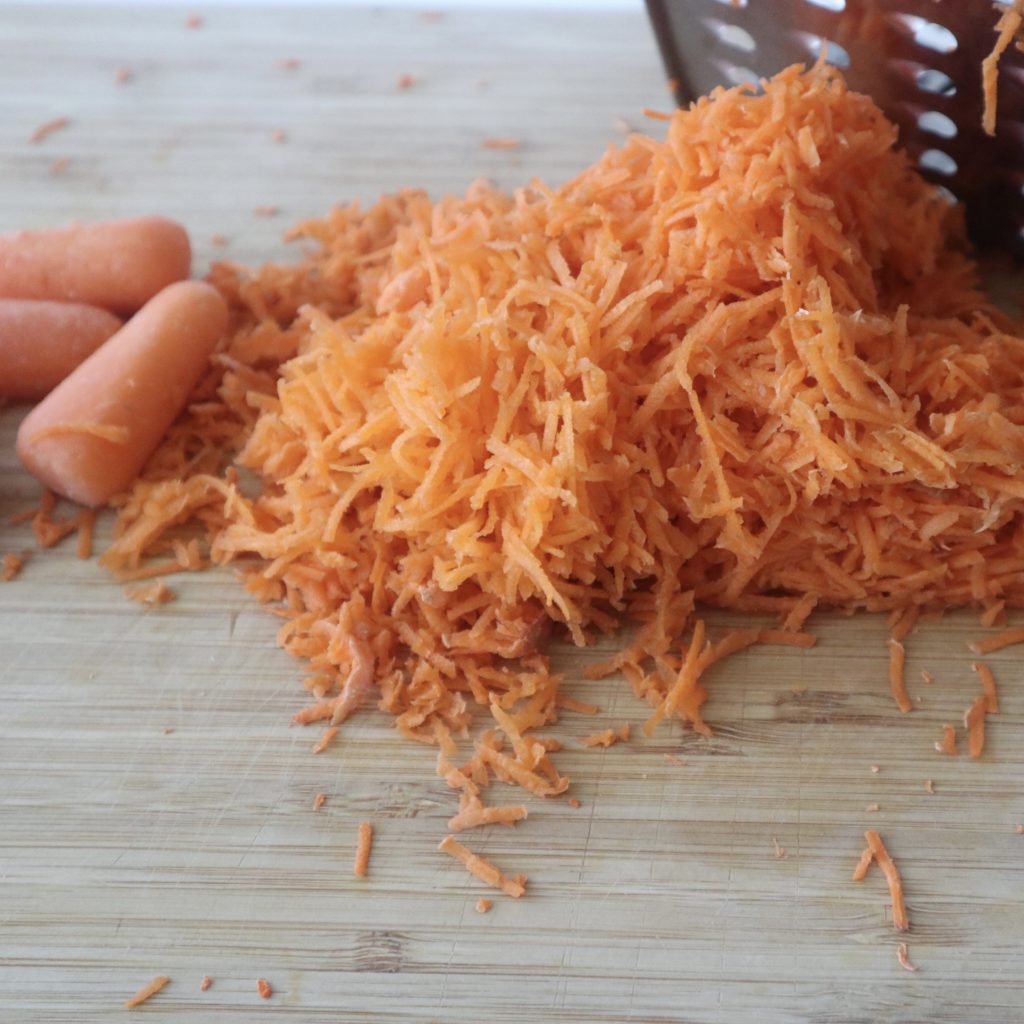 grated carrot on wood board