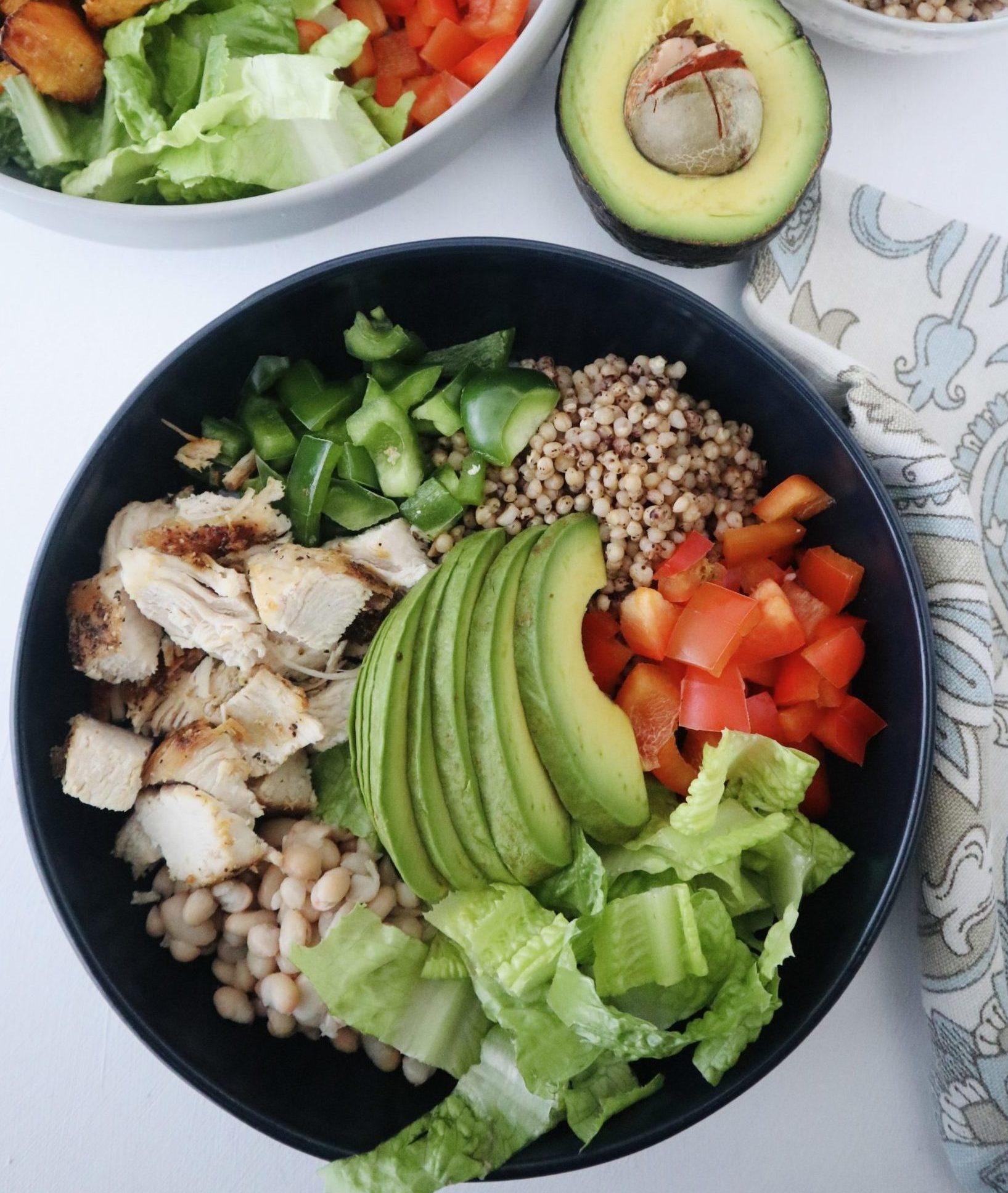 sorghum salad with chicken, avocado, peppers, lettuce