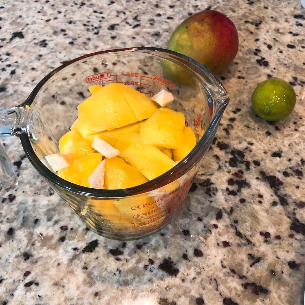 mango chunks, ginger, garlic in a measuring cup