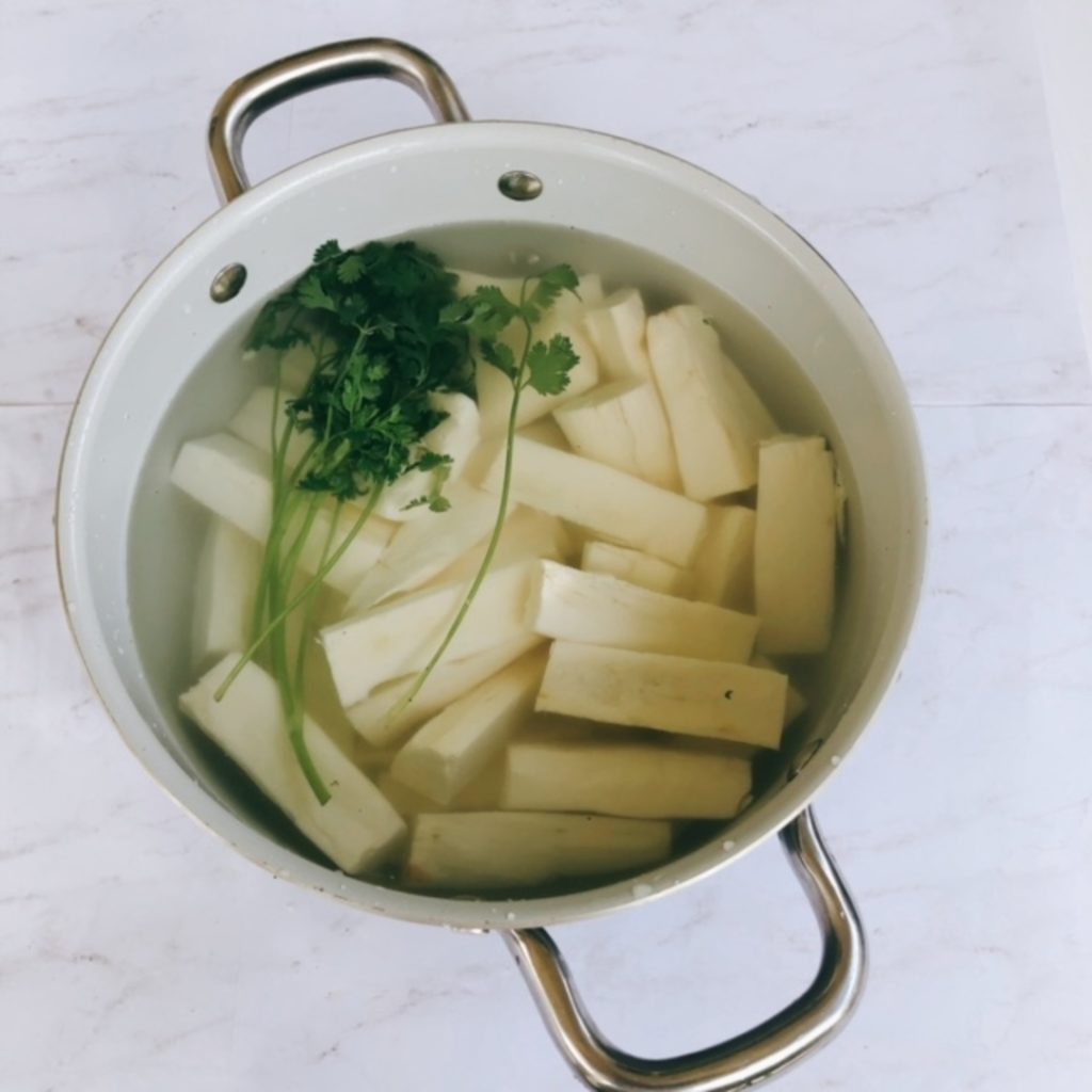 yuca in a large pot with water and cilantro