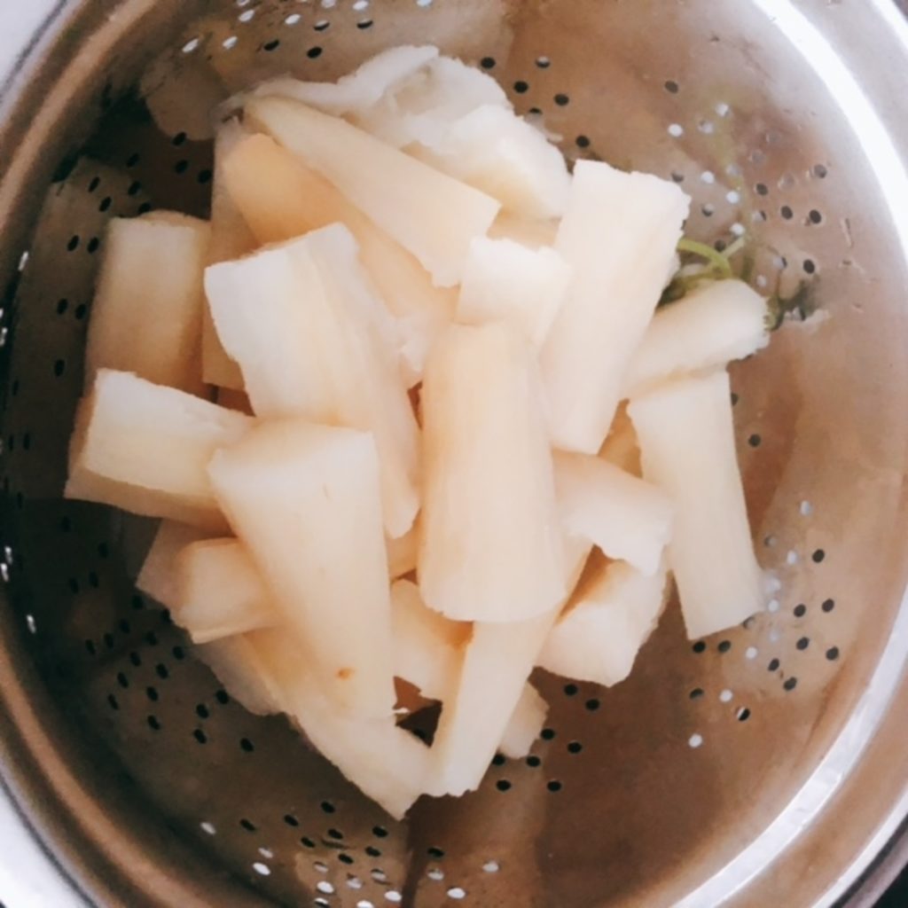 Boiled yuca in a colander