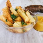 yuca fries in a bowl with spicy mango sauce