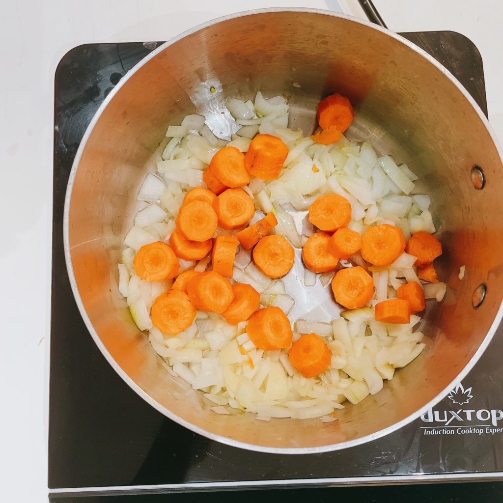 cooking onions, carrots, garlic in a medium pot