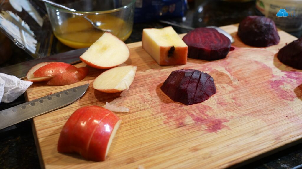 sliced apples and beets on cutting board.
