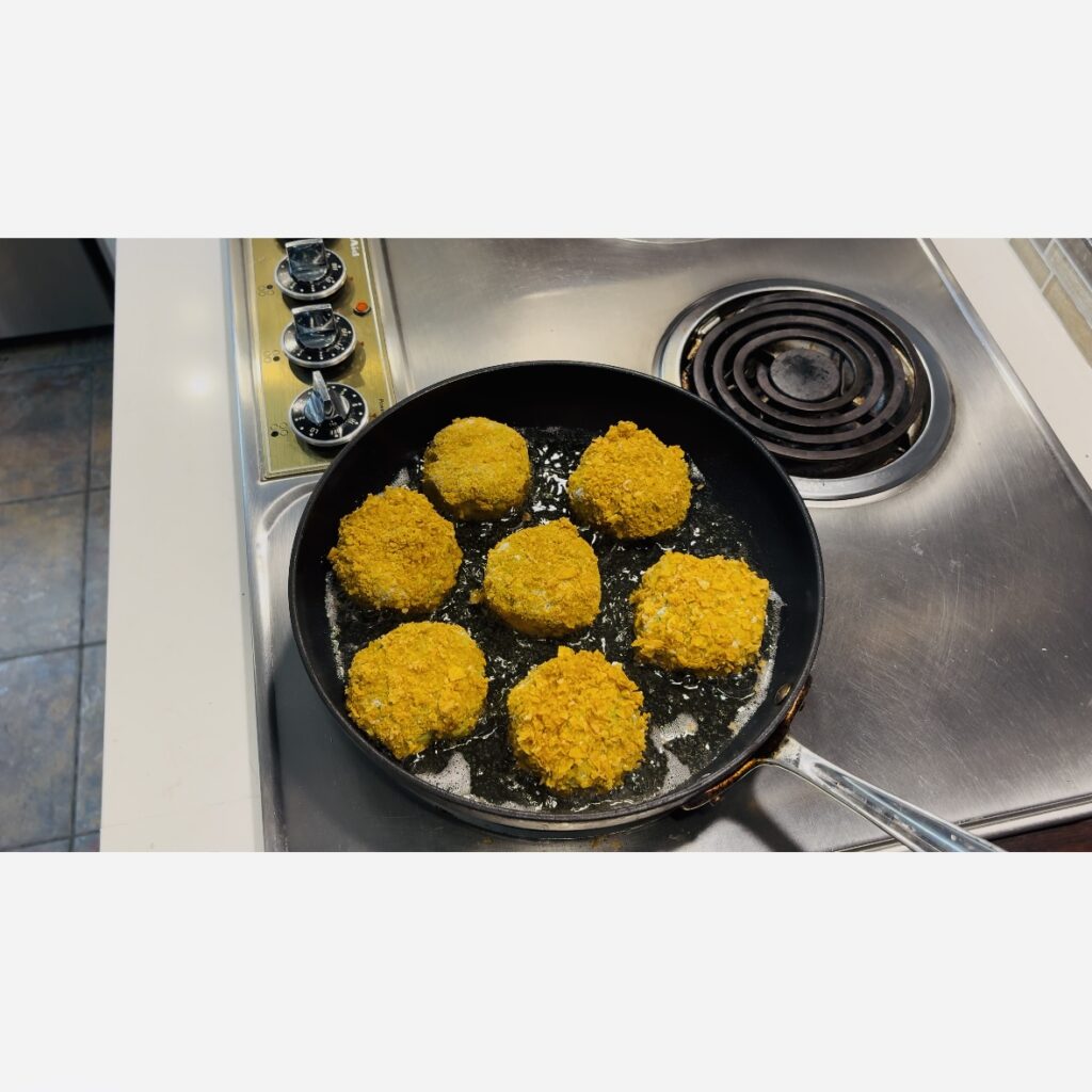 plantain patties in a frying pan on the stove.