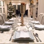 Christmas table setting and decor with white plates