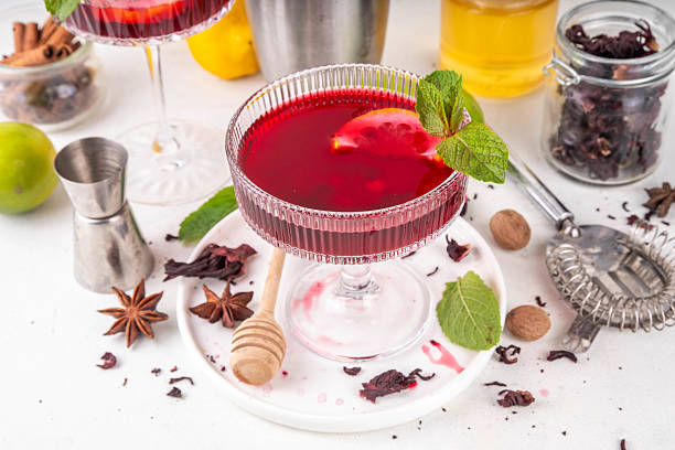 Tasty sweet sour aromatic hibiscus cocktail with alcohol, spices, honey, lemon or lime juice, copy space
