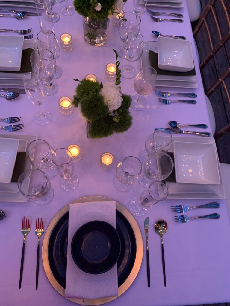 table set with white table cloth and white dinnerware