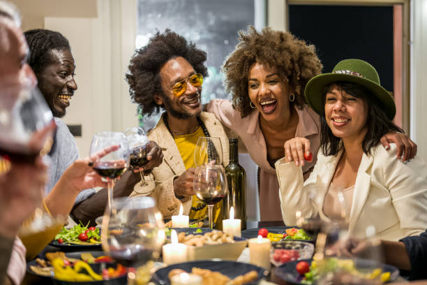 happy friends having fun at a vegan party, multi age friends vegetarian dinner celebration