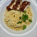 crispy chicken parmesan served over spaghetti